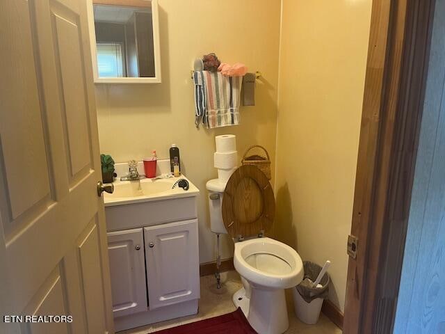 bathroom featuring vanity, toilet, and tile patterned flooring