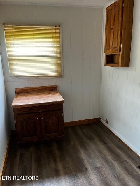 unfurnished office with dark wood-type flooring