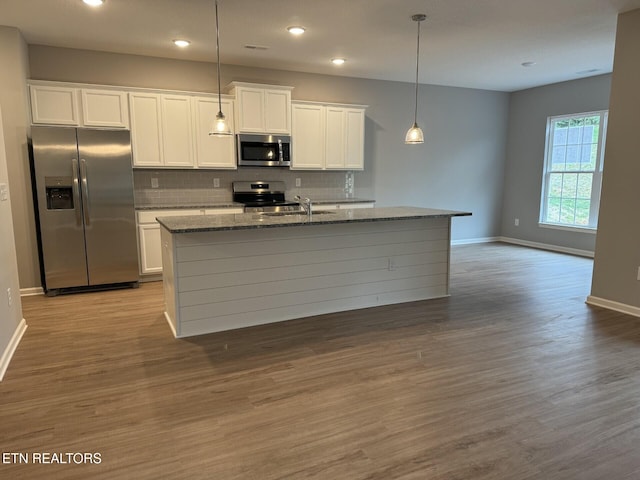 kitchen featuring white cabinetry, a kitchen island with sink, stainless steel appliances, and light wood-type flooring