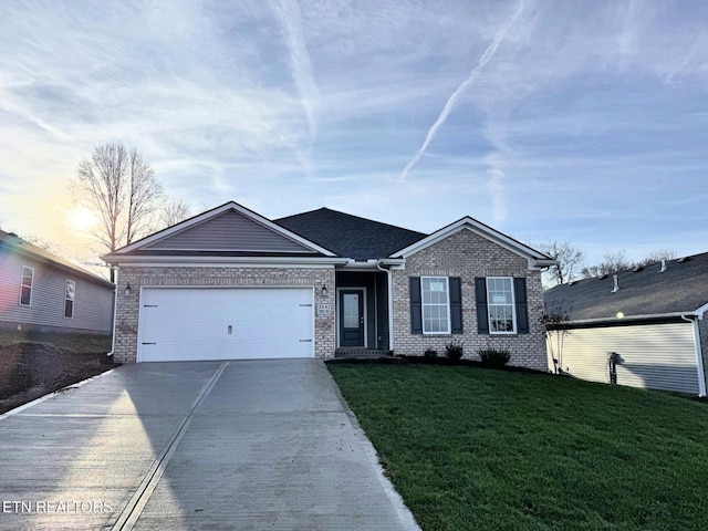 view of front of home with a garage and a yard