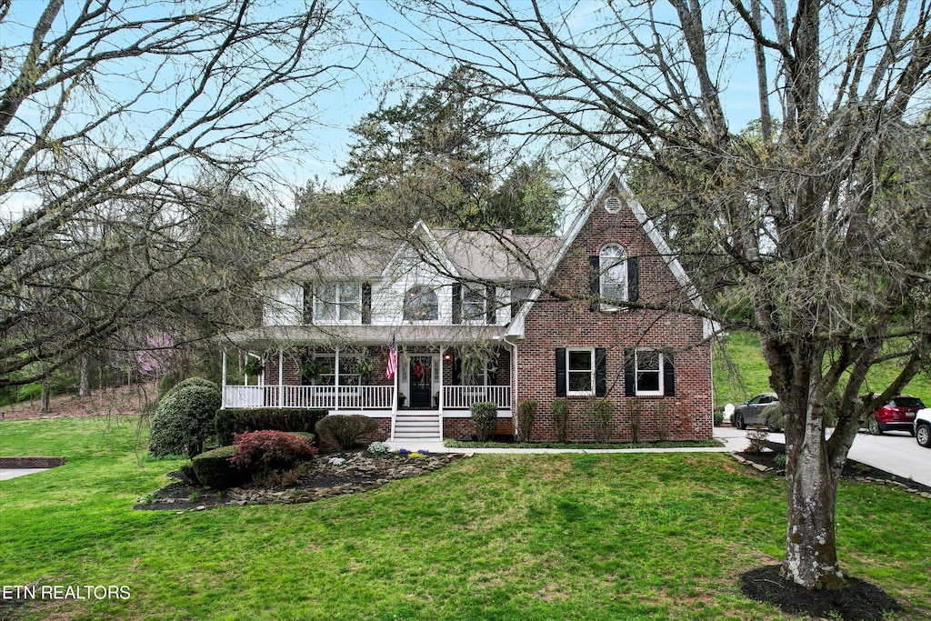 view of front facade with a porch and a front yard