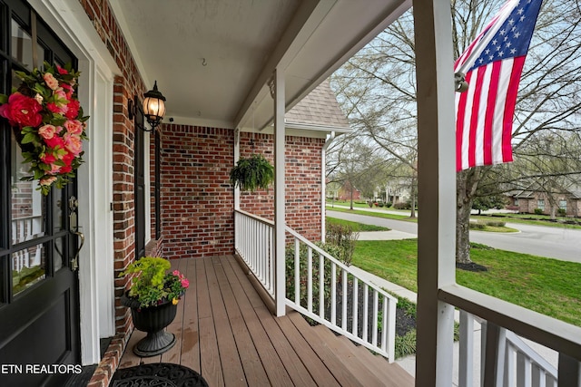 wooden terrace with a lawn