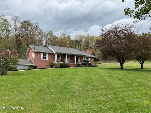 single story home with covered porch and a front yard