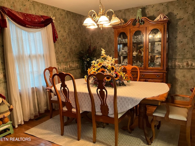 dining room featuring light hardwood / wood-style flooring and a chandelier