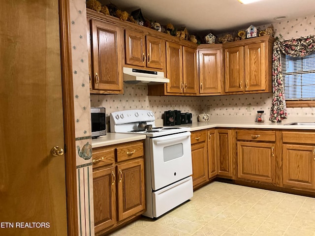 kitchen with white range with electric cooktop and light tile floors