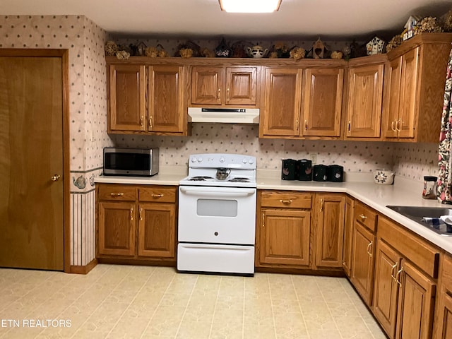 kitchen featuring white range with electric stovetop and light tile floors