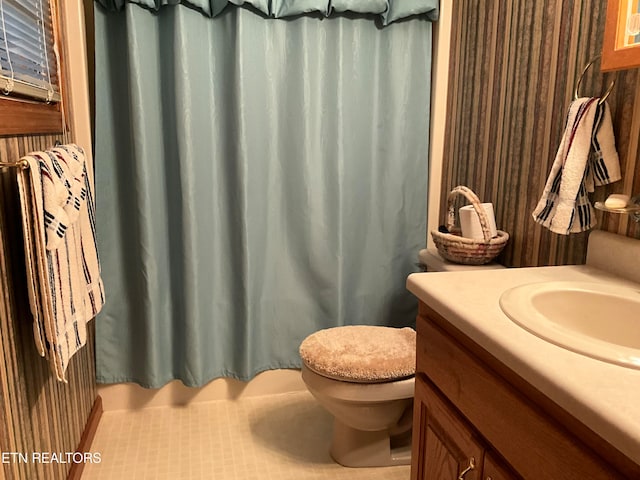 bathroom featuring vanity, toilet, and tile flooring