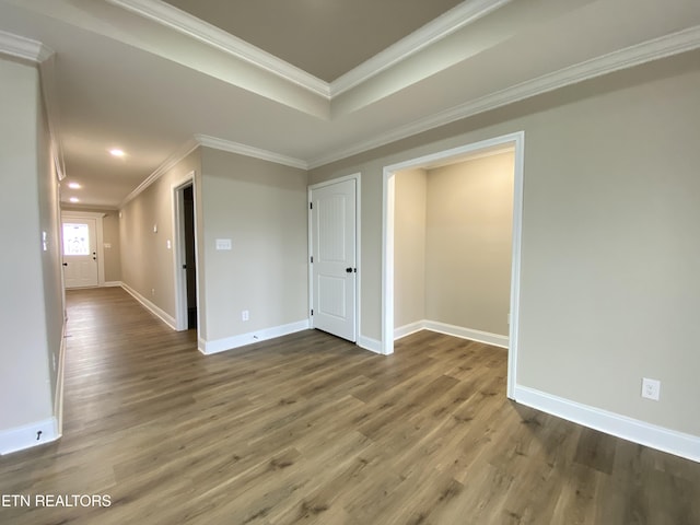 spare room featuring crown molding and hardwood / wood-style flooring