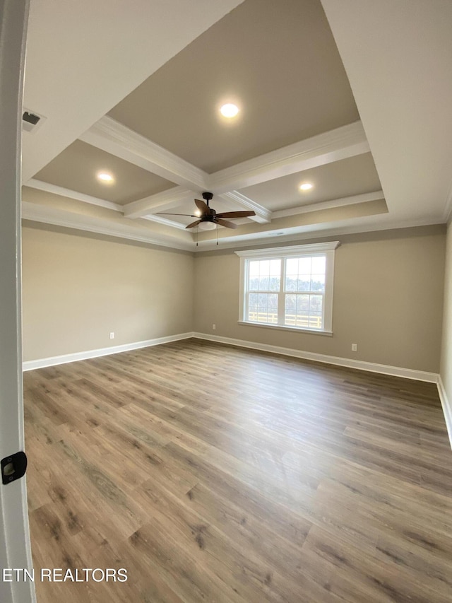 spare room featuring beam ceiling, ornamental molding, wood-type flooring, ceiling fan, and coffered ceiling