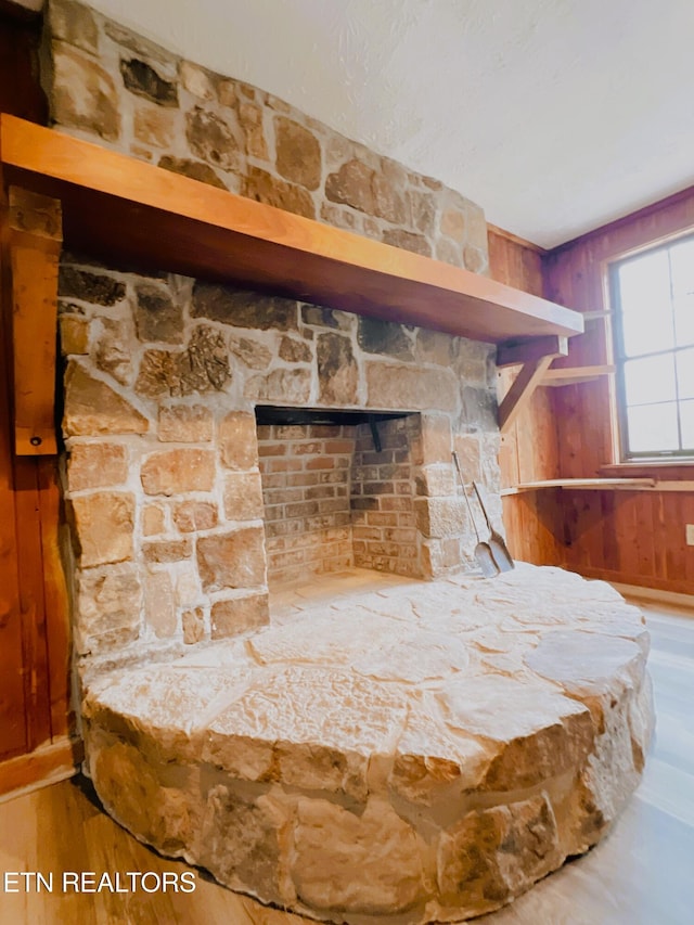 room details featuring wood-type flooring and wooden walls