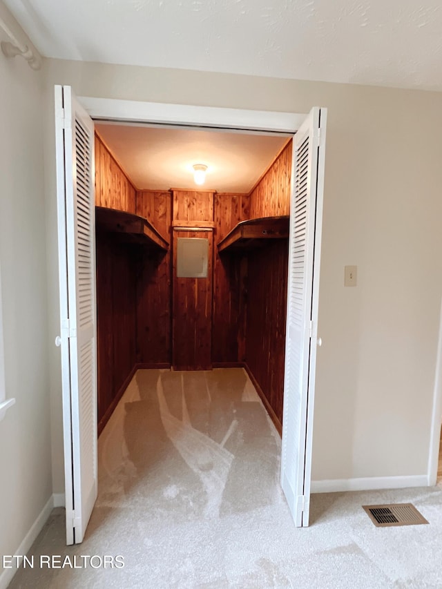 spacious closet featuring light carpet