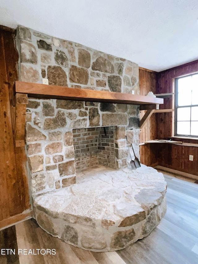 room details featuring wooden walls and hardwood / wood-style floors