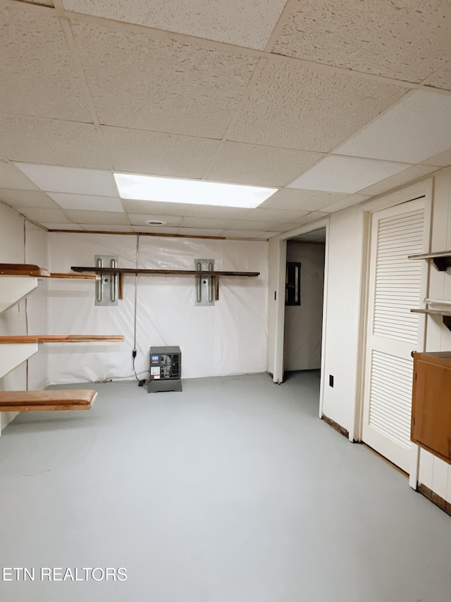 basement featuring a paneled ceiling