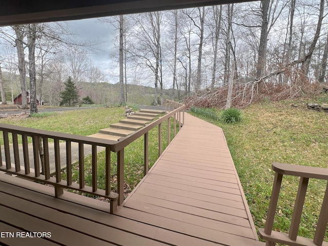 wooden terrace featuring a lawn