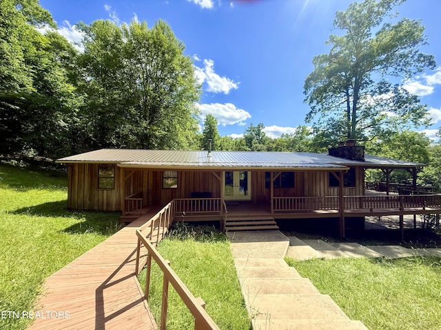 555 Lake Ln, New Tazewell, TN 37825 - view of front facade featuring board and batten siding, a front yard, a chimney, and metal roof