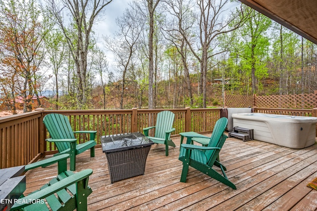 wooden terrace featuring a hot tub