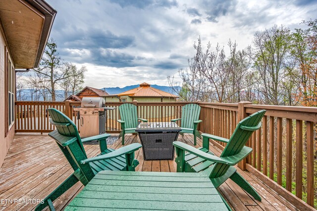 wooden terrace featuring grilling area