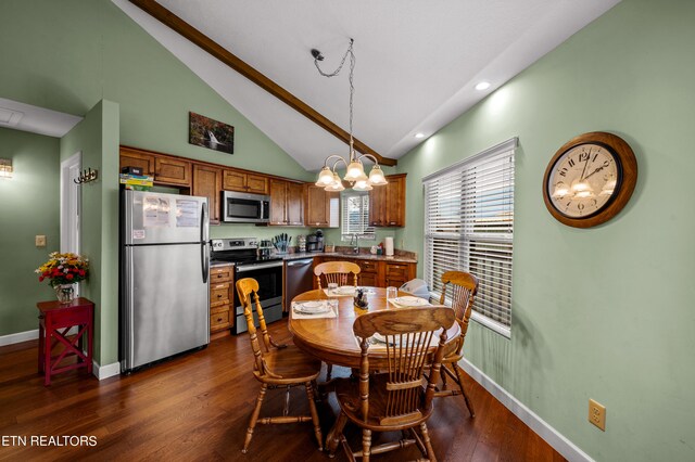 dining room with high vaulted ceiling, dark hardwood / wood-style flooring, sink, and an inviting chandelier