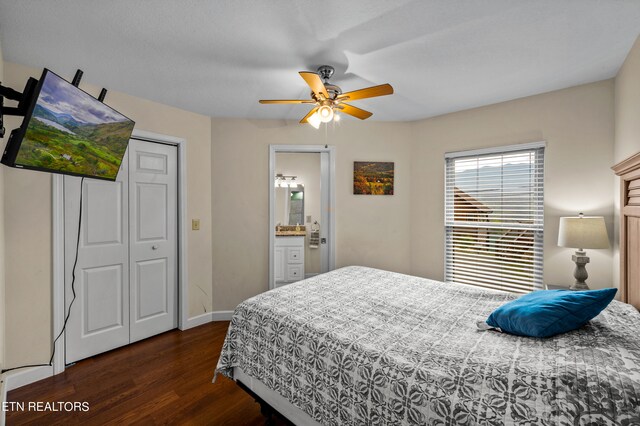 bedroom with dark hardwood / wood-style flooring, ceiling fan, a closet, and ensuite bathroom