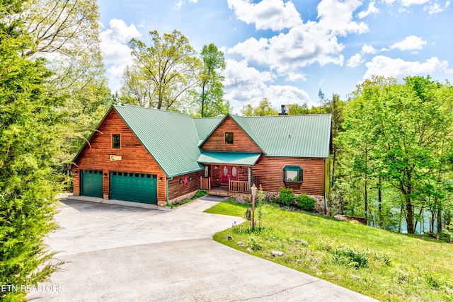 log cabin with a garage and a front lawn