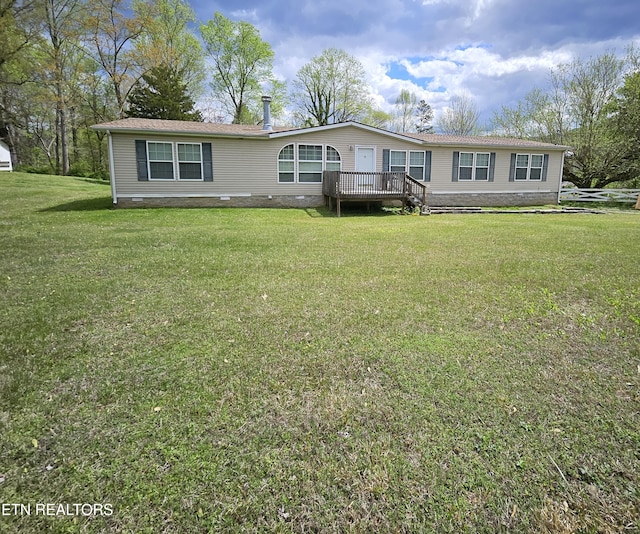 manufactured / mobile home featuring a front lawn and a deck