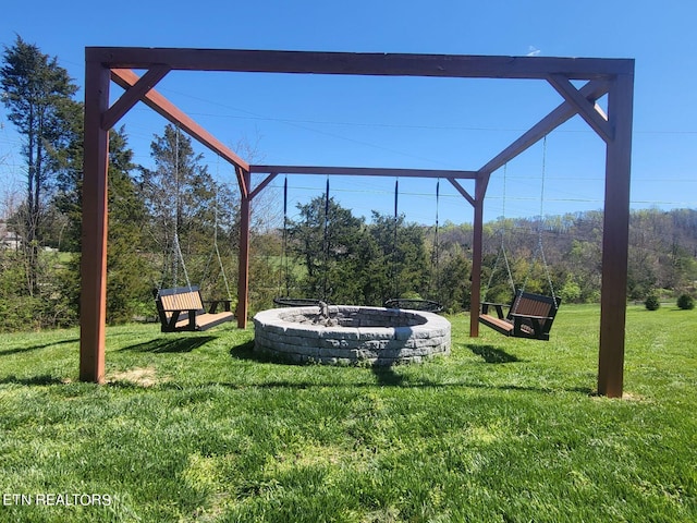 exterior space with a fire pit and a lawn