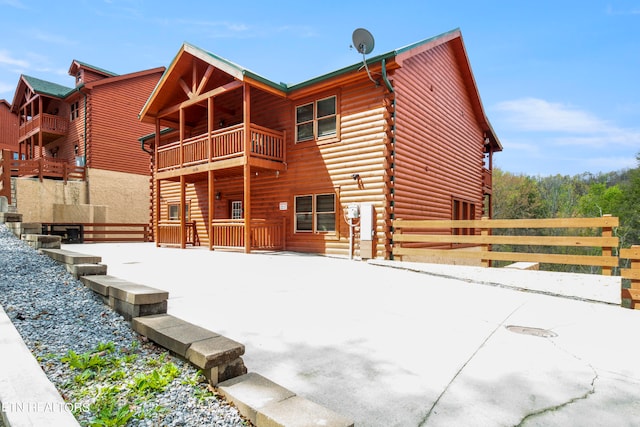 back of property featuring a balcony