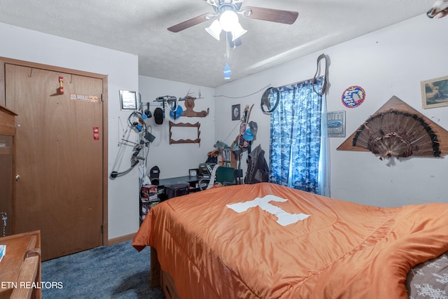 carpeted bedroom with a closet, ceiling fan, and a textured ceiling