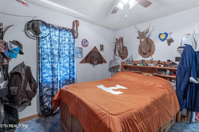 bedroom with ceiling fan, dark carpet, and a textured ceiling