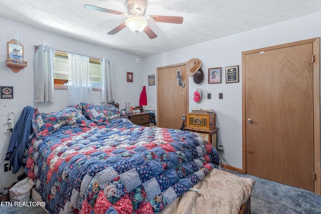 carpeted bedroom with a textured ceiling and ceiling fan