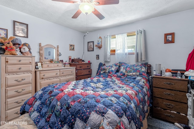 carpeted bedroom with ceiling fan and a textured ceiling