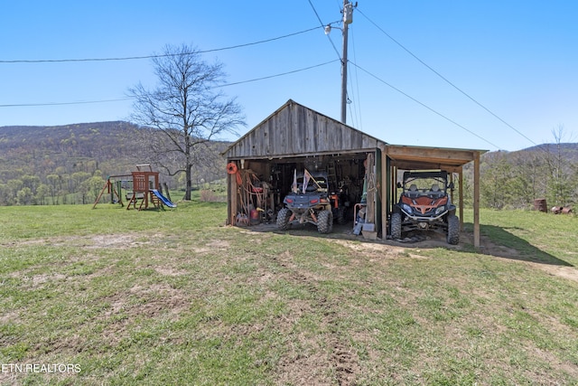 view of yard with an outdoor structure and a playground