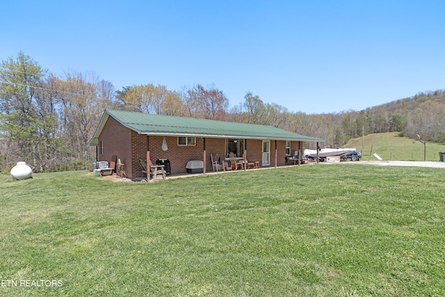 back of property featuring a yard