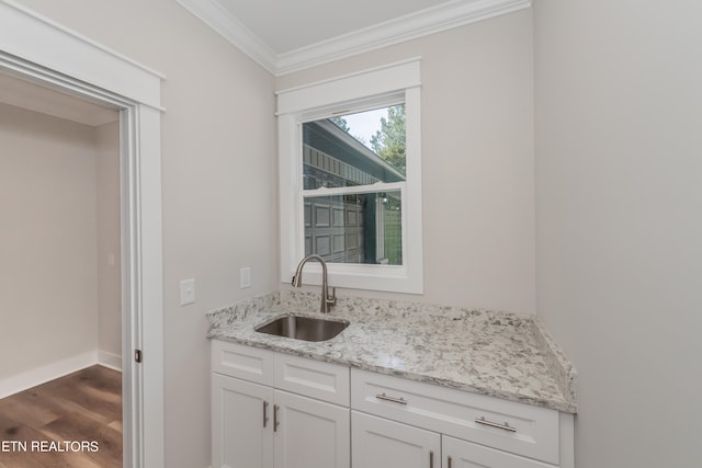 kitchen featuring crown molding, light stone countertops, sink, and white cabinets