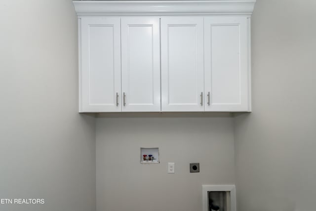 washroom featuring cabinets, hookup for a washing machine, and electric dryer hookup