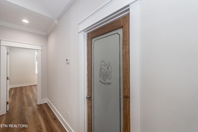 hall featuring ornamental molding and dark hardwood / wood-style floors