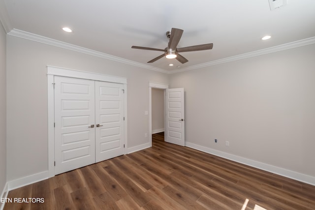 unfurnished bedroom with ornamental molding, dark hardwood / wood-style flooring, and a closet