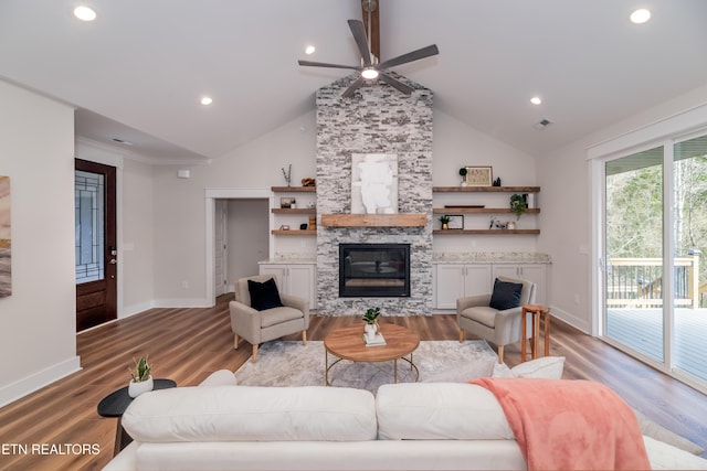 living room featuring a stone fireplace, wood-type flooring, and high vaulted ceiling