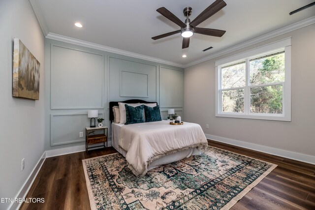 bedroom featuring crown molding, dark hardwood / wood-style floors, and ceiling fan