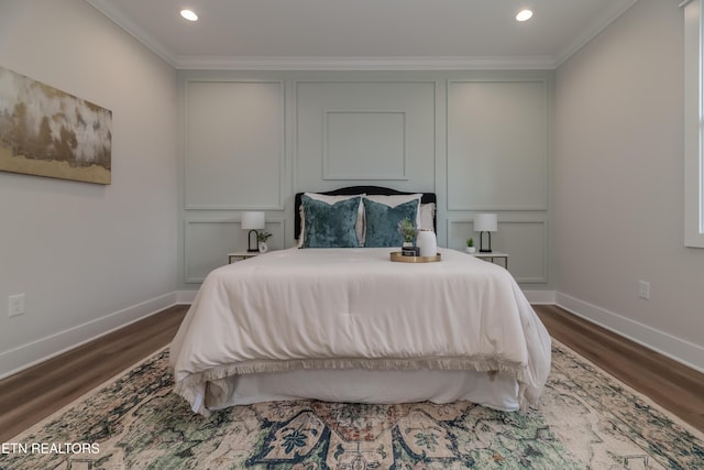 bedroom featuring crown molding and dark wood-type flooring