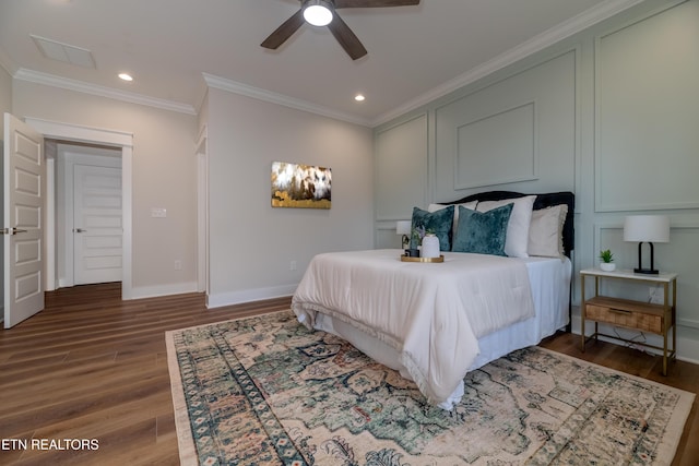 bedroom featuring crown molding, dark wood-type flooring, and ceiling fan