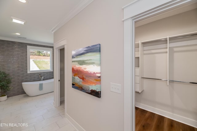 bathroom with ornamental molding and a washtub