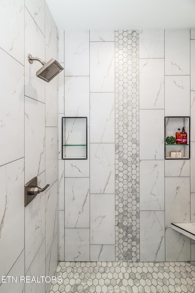 bathroom with tiled shower