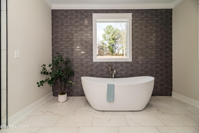 bathroom featuring crown molding and a tub