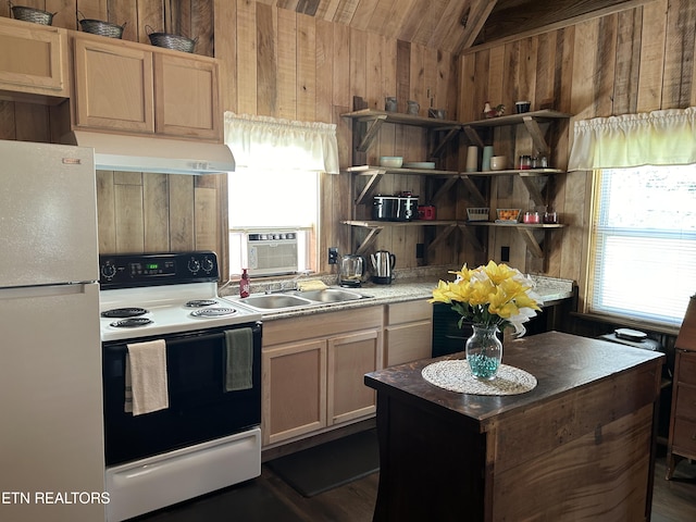 kitchen featuring sink, white appliances, lofted ceiling, and wood walls