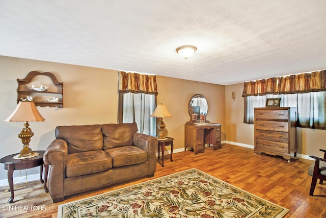 living room with hardwood / wood-style flooring and a textured ceiling