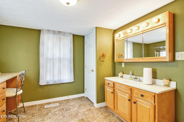 bathroom featuring tile floors and vanity with extensive cabinet space