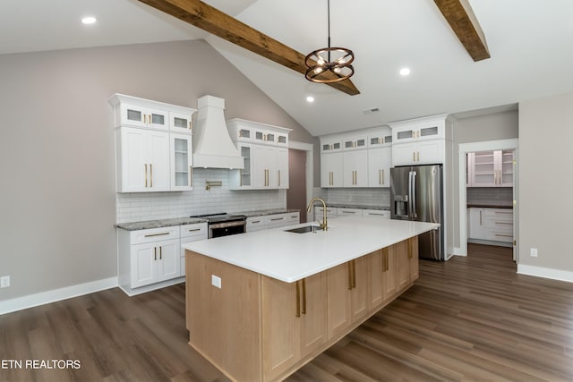 kitchen with sink, stainless steel appliances, a kitchen island with sink, and beamed ceiling