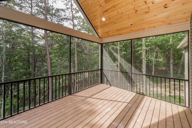 unfurnished sunroom featuring wooden ceiling and vaulted ceiling