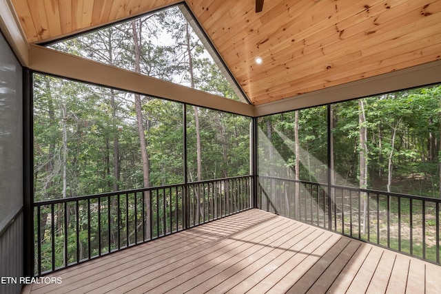 unfurnished sunroom featuring vaulted ceiling and wooden ceiling